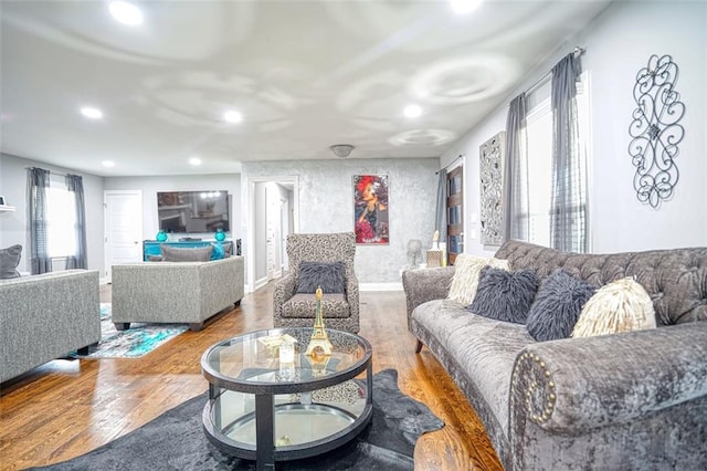 living room with wood finished floors and recessed lighting
