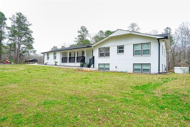 back of property featuring a lawn