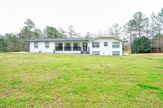 rear view of property featuring a lawn