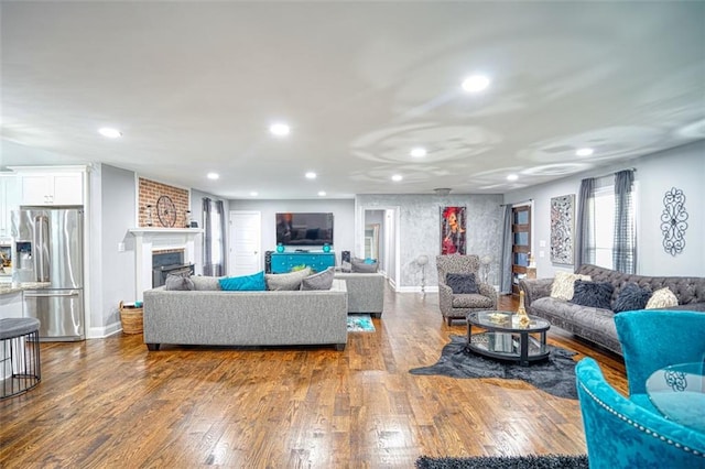 living area with a fireplace, baseboards, dark wood-style flooring, and recessed lighting