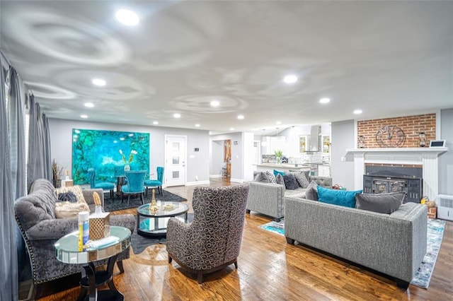 living area featuring recessed lighting, wood finished floors, a fireplace, and baseboards