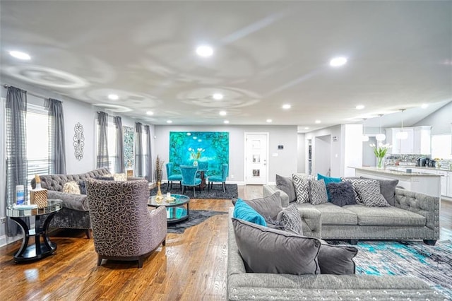 living room with recessed lighting, wood finished floors, and baseboards