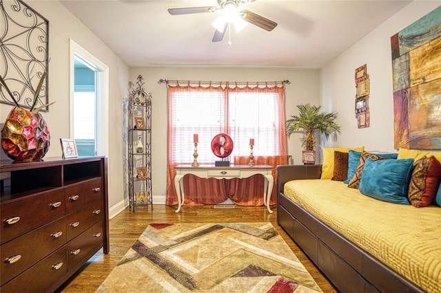 bedroom with baseboards, a ceiling fan, and wood finished floors