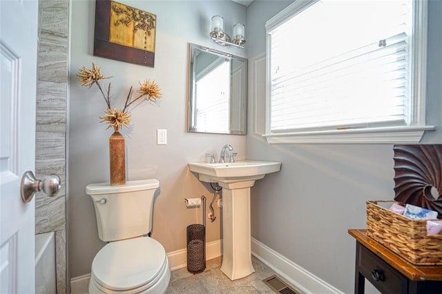 bathroom featuring baseboards, toilet, and visible vents