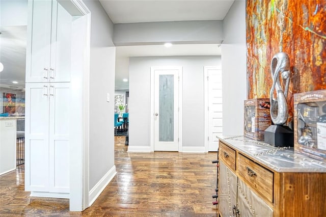 foyer with baseboards, dark wood-style floors, and recessed lighting
