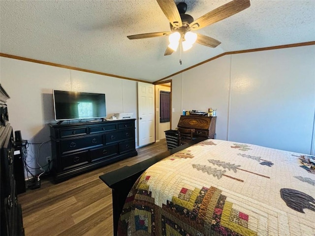 bedroom with lofted ceiling, a textured ceiling, crown molding, and wood finished floors