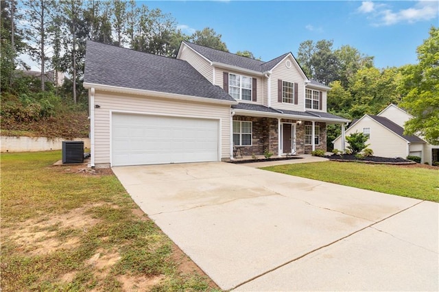 view of front property with central air condition unit, a garage, and a front yard