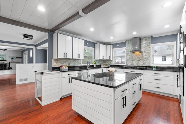 1647 Grandeus Ln SW, Stone Mountain, GA 30087 - kitchen featuring wall chimney exhaust hood, crown molding, dark countertops, dishwasher, and gas cooktop