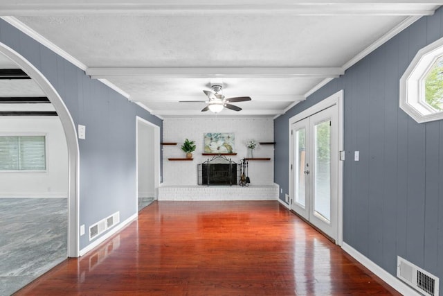 1647 Grandeus Ln SW, Stone Mountain, GA 30087 - unfurnished living room with beam ceiling, wood finished floors, arched walkways, a ceiling fan, and ornamental molding