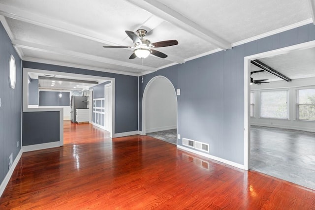 1647 Grandeus Ln SW, Stone Mountain, GA 30087 - unfurnished living room with a ceiling fan, arched walkways, wood finished floors, baseboards, and beamed ceiling