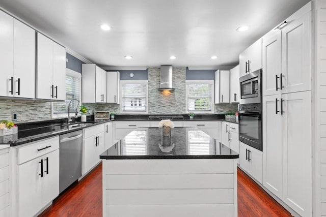 1647 Grandeus Ln SW, Stone Mountain, GA 30087 - kitchen with appliances with stainless steel finishes, a sink, plenty of natural light, wall chimney range hood, and ornamental molding