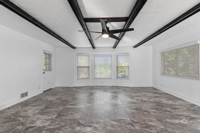 1647 Grandeus Ln SW, Stone Mountain, GA 30087 - unfurnished room featuring a ceiling fan, plenty of natural light, beamed ceiling, and baseboards