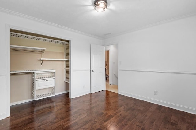1647 Grandeus Ln SW, Stone Mountain, GA 30087 - unfurnished bedroom with ornamental molding, wood finished floors, a closet, and baseboards