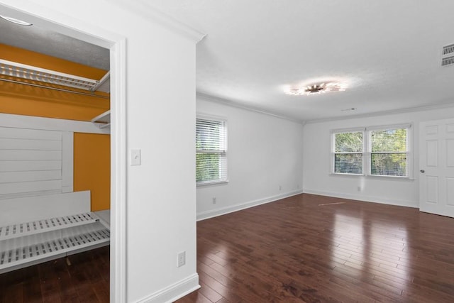 1647 Grandeus Ln SW, Stone Mountain, GA 30087 - unfurnished bedroom featuring ornamental molding, hardwood / wood-style flooring, multiple windows, and baseboards