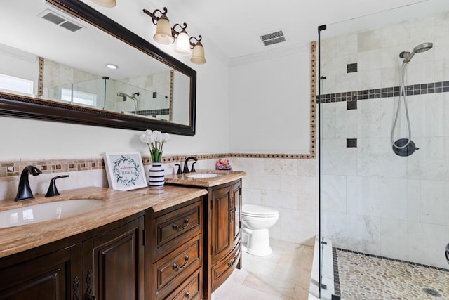 1647 Grandeus Ln SW, Stone Mountain, GA 30087 - bathroom with double vanity, tile walls, a stall shower, ornamental molding, and toilet