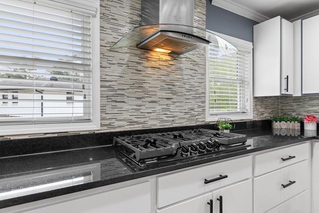 1647 Grandeus Ln SW, Stone Mountain, GA 30087 - kitchen featuring decorative backsplash, black gas cooktop, white cabinets, ornamental molding, and exhaust hood