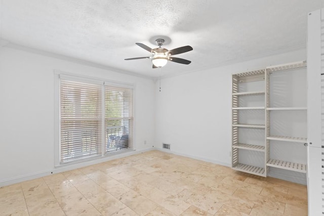 1647 Grandeus Ln SW, Stone Mountain, GA 30087 - empty room featuring ceiling fan, crown molding, a textured ceiling, and baseboards
