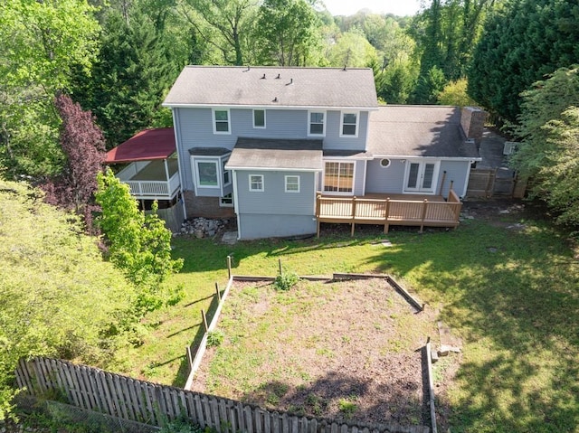 1647 Grandeus Ln SW, Stone Mountain, GA 30087 - rear view of property featuring a wooden deck, a yard, a wooded view, and a garden