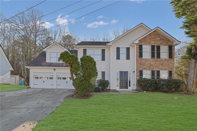 view of front of home featuring a garage and a front lawn