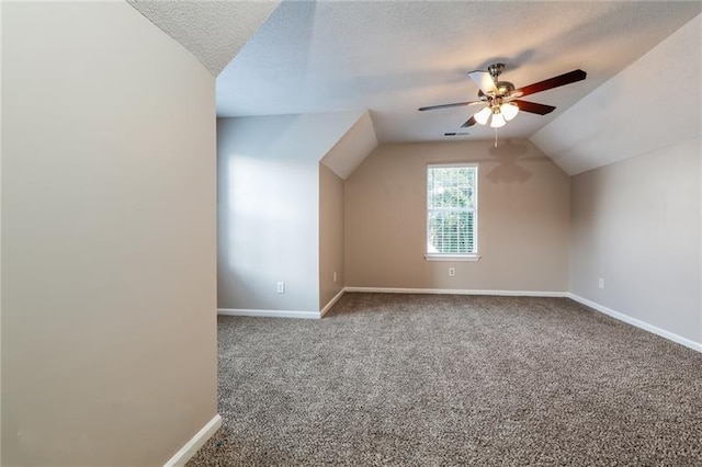 additional living space with lofted ceiling, a ceiling fan, baseboards, and carpet flooring