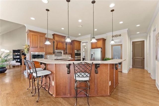 4729 Deer Creek Ct, Flowery Branch, GA 30542 - kitchen featuring stainless steel appliances, custom range hood, a kitchen bar, decorative backsplash, and light wood-style flooring