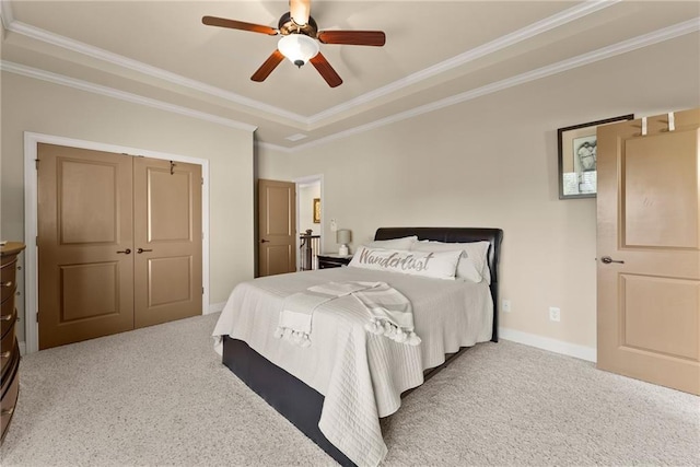 4729 Deer Creek Ct, Flowery Branch, GA 30542 - carpeted bedroom featuring ornamental molding, a tray ceiling, ceiling fan, baseboards, and a closet