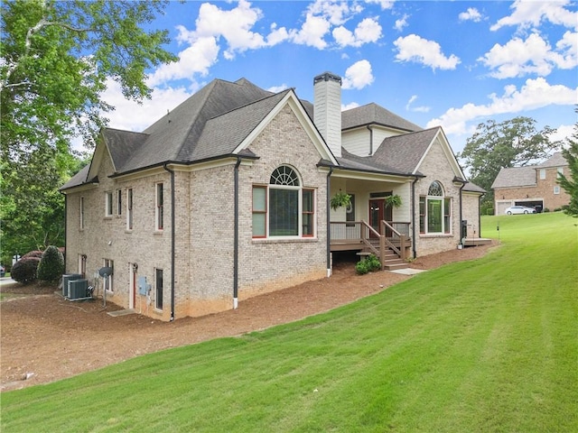 4729 Deer Creek Ct, Flowery Branch, GA 30542 - rear view of property featuring a chimney, a yard, brick siding, and roof with shingles