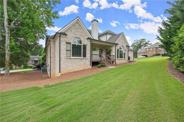 4729 Deer Creek Ct, Flowery Branch, GA 30542 - rear view of house with a chimney, a lawn, brick siding, and a porch