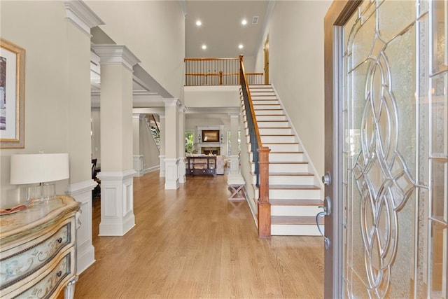 4729 Deer Creek Ct, Flowery Branch, GA 30542 - foyer entrance with decorative columns, stairs, light wood-type flooring, a high ceiling, and recessed lighting