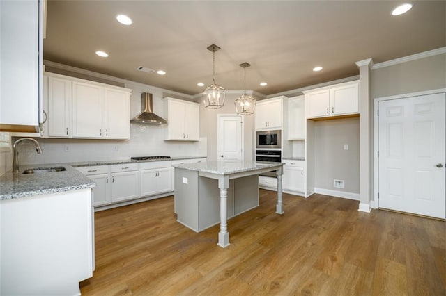 8245 Dawson View Way, Cumming, GA 30028 - kitchen featuring wall chimney exhaust hood, appliances with stainless steel finishes, a sink, crown molding, and white cabinetry