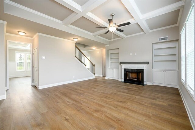 8245 Dawson View Way, Cumming, GA 30028 - unfurnished living room featuring ceiling fan, light wood-type flooring, a fireplace, baseboards, and beamed ceiling