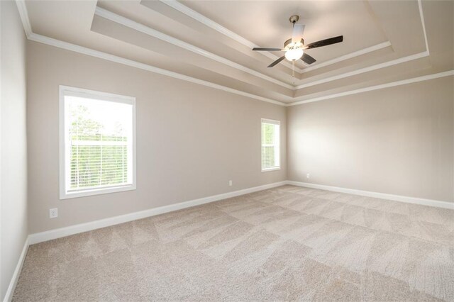 8245 Dawson View Way, Cumming, GA 30028 - empty room featuring a tray ceiling, ornamental molding, light carpet, baseboards, and ceiling fan