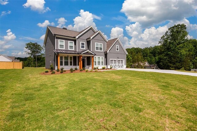 8245 Dawson View Way, Cumming, GA 30028 - view of front of house featuring driveway, board and batten siding, a standing seam roof, covered porch, and metal roof