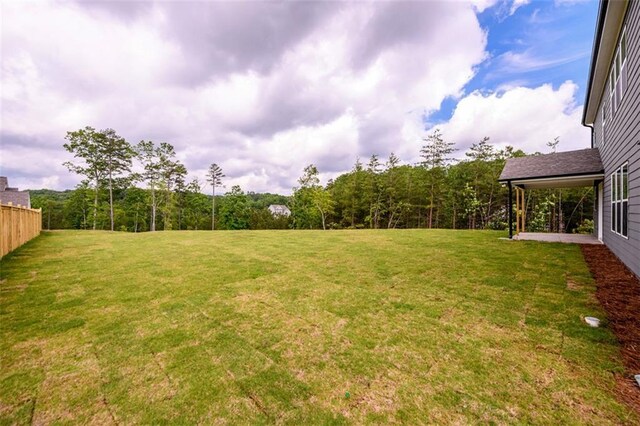 8245 Dawson View Way, Cumming, GA 30028 - view of grassy yard with a wooded view