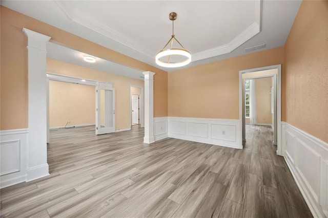 5156 Amberden Hall Dr, Suwanee, GA 30024 - unfurnished room with a tray ceiling, decorative columns, a decorative wall, crown molding, and wood finished floors