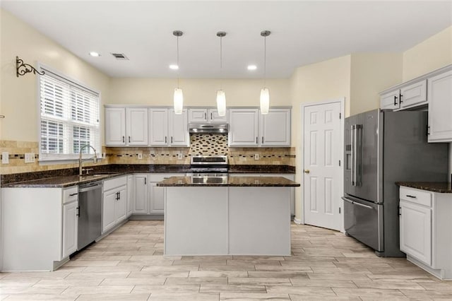5156 Amberden Hall Dr, Suwanee, GA 30024 - kitchen with stainless steel appliances, under cabinet range hood, decorative backsplash, light wood-style floors, and recessed lighting