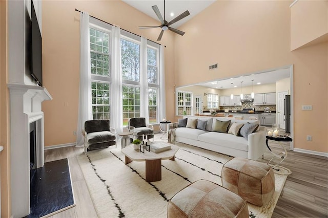 5156 Amberden Hall Dr, Suwanee, GA 30024 - living room with a high ceiling, a ceiling fan, baseboards, light wood-type flooring, and recessed lighting