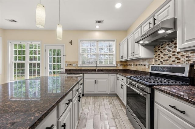 5156 Amberden Hall Dr, Suwanee, GA 30024 - kitchen with stainless steel gas range oven, under cabinet range hood, healthy amount of natural light, a sink, and recessed lighting