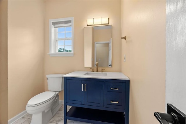 5156 Amberden Hall Dr, Suwanee, GA 30024 - bathroom with toilet, baseboards, vanity, and marble look tile flooring