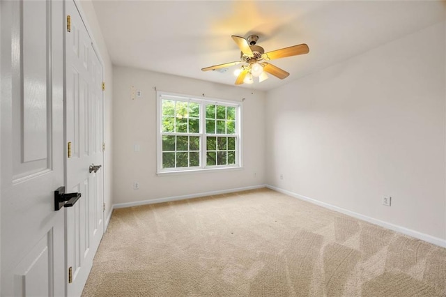 5156 Amberden Hall Dr, Suwanee, GA 30024 - spare room with baseboards, light carpet, and a ceiling fan