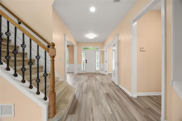 5156 Amberden Hall Dr, Suwanee, GA 30024 - foyer featuring light wood finished floors, stairs, and baseboards