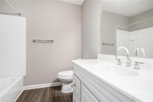 6354 Shannon Pkwy Unit 30C, Union City, GA 30291 - bathroom featuring toilet, wood finished floors, vanity, baseboards, and a textured ceiling