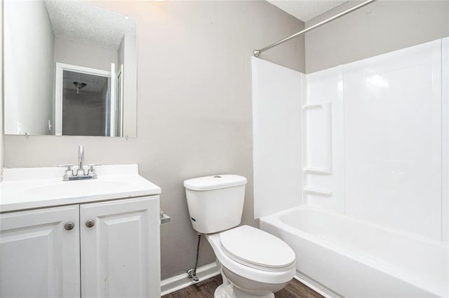 6354 Shannon Pkwy Unit 30C, Union City, GA 30291 - full bath featuring toilet, vanity, wood finished floors, shower / washtub combination, and a textured ceiling