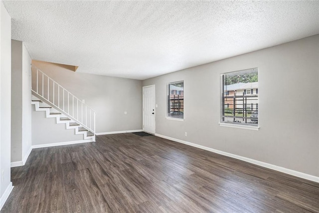 6354 Shannon Pkwy Unit 30C, Union City, GA 30291 - entrance foyer featuring dark wood-style floors, baseboards, a textured ceiling, and stairway