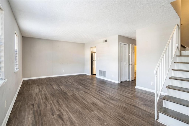 6354 Shannon Pkwy Unit 30C, Union City, GA 30291 - unfurnished room featuring a textured ceiling, wood finished floors, stairs, and baseboards