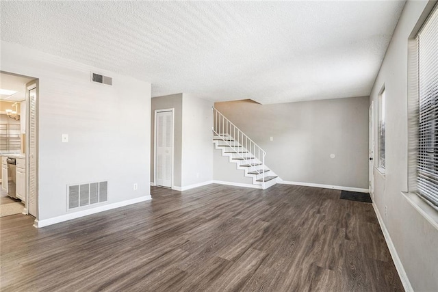 6354 Shannon Pkwy Unit 30C, Union City, GA 30291 - unfurnished living room with wood finished floors, stairs, baseboards, and a textured ceiling