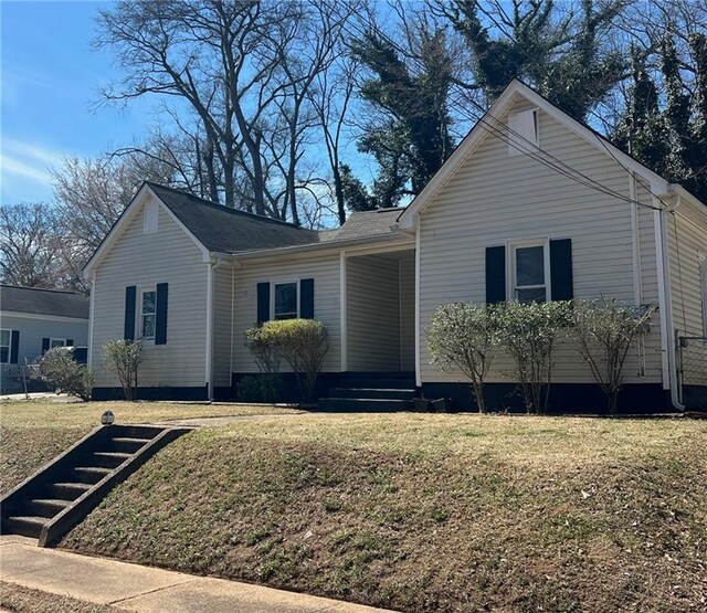 bungalow-style house featuring a front yard