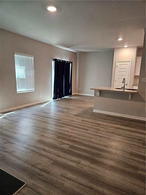 kitchen with sink, white cabinetry, stainless steel appliances, and light hardwood / wood-style floors