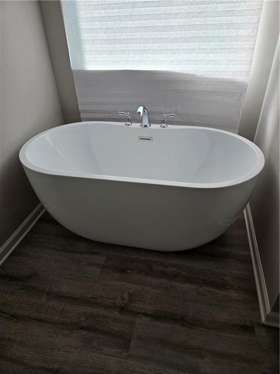 bathroom featuring hardwood / wood-style flooring and a bathing tub