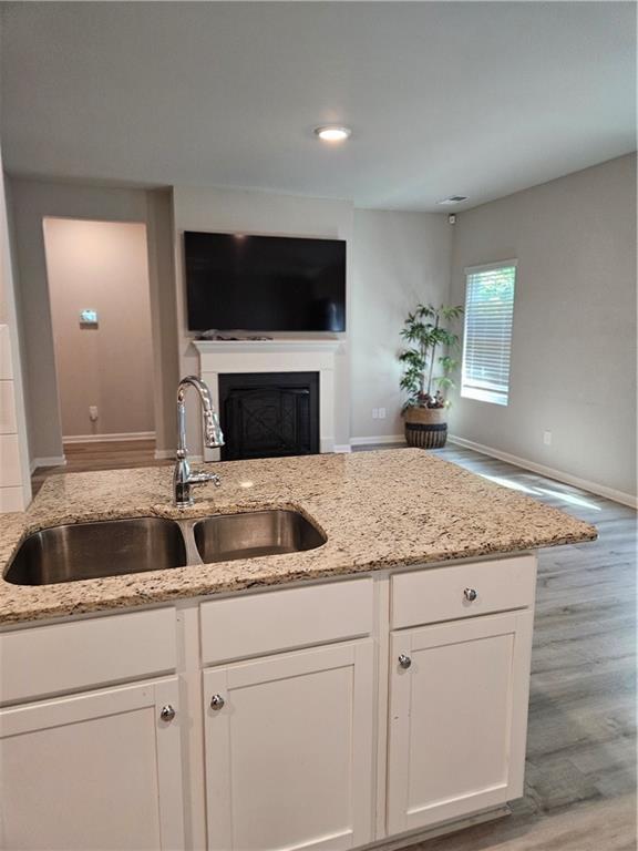 bathroom with hardwood / wood-style floors and a shower with shower door